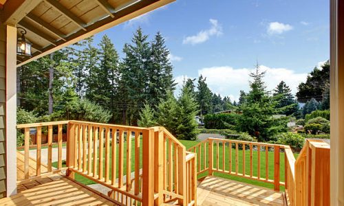 Wooden walkout deck with patio area overlooking backyard. Northwest, USA Wooden walkout deck with patio area overlooking backyard. Northwest, USA